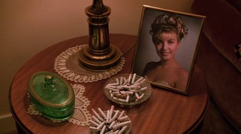 Movie still from “Twin Peaks: Fire Walk with Me” (1992), directed by David Lynch – A picture of a young girl sitting on a table; Extreme Close Up shot, Overhead angle