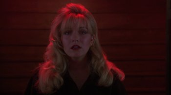 Movie still from “Twin Peaks: Fire Walk with Me” (1992), directed by David Lynch – A woman with blonde hair and a black shirt; Close Up shot, Low angle
