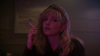 Movie still from “Twin Peaks: Fire Walk with Me” (1992), directed by David Lynch – A woman is holding a cigarette in her mouth; Close Up shot, Low angle