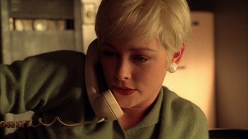 Movie still from “Twin Peaks: Fire Walk with Me” (1992), directed by David Lynch – A woman with short blonde hair talking on a phone; Close Up shot, Low angle