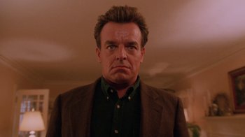 Movie still from “Twin Peaks: Fire Walk with Me” (1992), directed by David Lynch – A person wearing a suit and tie; Close Up shot, Low angle