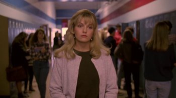 Movie still from “Twin Peaks: Fire Walk with Me” (1992), directed by David Lynch – A woman standing in the hallway of a building; Close Up shot, Over the shoulder angle
