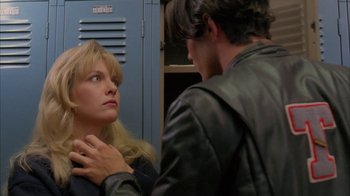 Movie still from “Twin Peaks: Fire Walk with Me” (1992), directed by David Lynch – A man and a woman looking at one another in front of a locker; Close Up shot, Over the shoulder angle