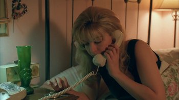 Movie still from “Twin Peaks: Fire Walk with Me” (1992), directed by David Lynch – A woman talking on a phone while sitting on a bed; Close Up shot, High angle