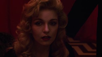 Movie still from “Twin Peaks: Fire Walk with Me” (1992), directed by David Lynch – A person with long blonde curly hair; Close Up shot, Low angle