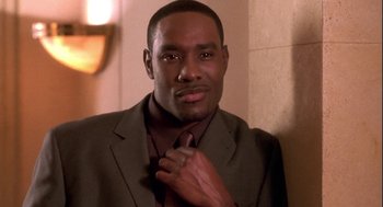 Movie still from “Two Can Play That Game” (2001), directed by Mark Brown – A person wearing a suit and a tie; Close Up shot, High angle