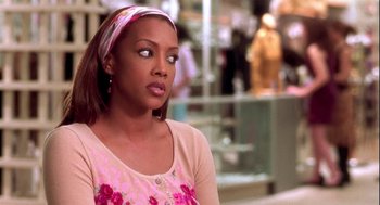 Movie still from “Two Can Play That Game” (2001), directed by Mark Brown – A woman in a pink shirt and a pink headband; Close Up shot, Over the shoulder angle