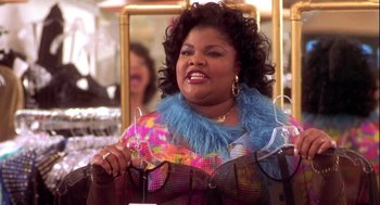 Movie still from “Two Can Play That Game” (2001), directed by Mark Brown – A woman in a colorful outfit holding a wine glass; Medium shot, Over the shoulder angle