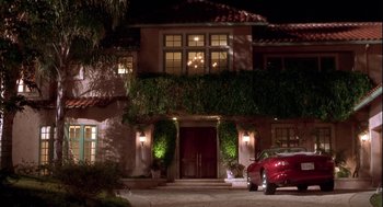 Movie still from “Two Can Play That Game” (2001), directed by Mark Brown – A car parked in front of a house at night; Extreme Wide shot, Low angle