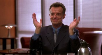 Movie still from “Two Can Play That Game” (2001), directed by Mark Brown – A man in a suit and tie clapping his hands; Close Up shot, Low angle