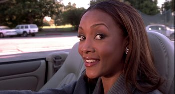 Movie still from “Two Can Play That Game” (2001), directed by Mark Brown – A person sitting in a car; Close Up shot, Over the shoulder angle
