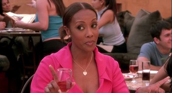 Movie still from “Two Can Play That Game” (2001), directed by Mark Brown – A woman holding a glass of wine in her right hand; Close Up shot, Over the shoulder angle