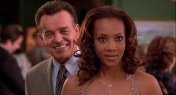 Movie still from “Two Can Play That Game” (2001), directed by Mark Brown – A man standing next to a woman in a dress; Close Up shot, Over the shoulder angle