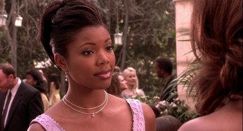 Movie still from “Two Can Play That Game” (2001), directed by Mark Brown – A woman in a pink dress; Close Up shot, Over the shoulder angle