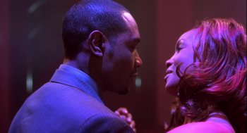 Movie still from “Two Can Play That Game” (2001), directed by Mark Brown – A man and a woman are looking into each others eyes; Close Up shot, Low angle