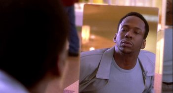 Movie still from “Two Can Play That Game” (2001), directed by Mark Brown – A man sitting in front of a mirror looking at himself in the mirror; Close Up shot, Over the shoulder angle