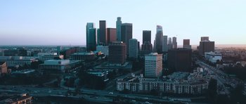 Movie still from “Two Witches” (2021), directed by Pierre Tsigaridis – An aerial view of a large city at dusk; Extreme Wide shot, Low angle