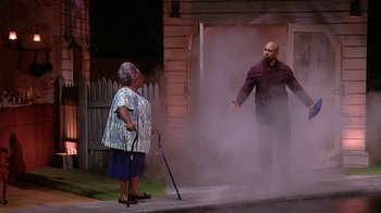 Movie still from “Madea on the Run” (2017), directed by Derrick Doose – An older woman and a man are standing in front of a door; Wide shot, Low angle