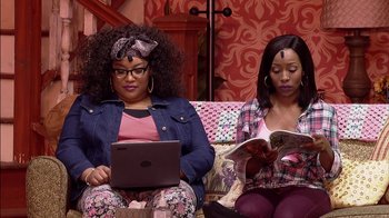 Movie still from “Madea on the Run” (2017), directed by Derrick Doose – A couple of women sitting next to each other on top of a couch; Medium shot, High angle