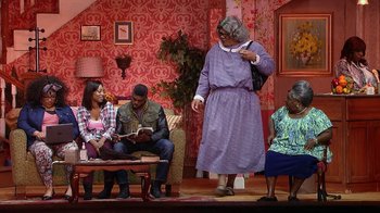Movie still from “Madea on the Run” (2017), directed by Derrick Doose – A group of people sitting on top of a couch; Wide shot, High angle