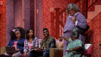 Movie still from “Madea on the Run” (2017), directed by Derrick Doose – A group of people sitting on top of a couch; Wide shot, High angle
