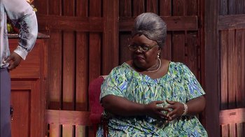 Movie still from “Madea on the Run” (2017), directed by Derrick Doose – An older woman sitting on top of a wooden bench; Medium shot, Over the shoulder angle