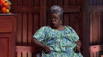 Movie still from “Madea on the Run” (2017), directed by Derrick Doose – An older woman sitting on top of a wooden bench; Medium shot, High angle