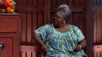 Movie still from “Madea on the Run” (2017), directed by Derrick Doose – An older woman sitting on top of a wooden bench; Medium shot, Over the shoulder angle