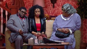 Movie still from “Madea on the Run” (2017), directed by Derrick Doose – A group of people sitting on a couch in a room; Medium shot, High angle