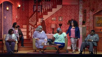 Movie still from “Madea on the Run” (2017), directed by Derrick Doose – A group of women sitting on a couch in a living room; Wide shot, High angle