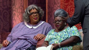 Movie still from “Madea on the Run” (2017), directed by Derrick Doose – A couple of women sitting next to each other on a couch; Medium shot, Over the shoulder angle