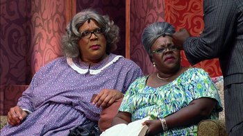 Movie still from “Madea on the Run” (2017), directed by Derrick Doose – A couple of women sitting next to each other on a couch; Medium shot, Over the shoulder angle