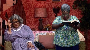 Movie still from “Madea on the Run” (2017), directed by Derrick Doose – Two older women are sitting in a living room; Medium shot, High angle