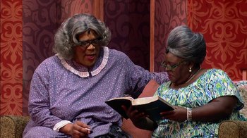 Movie still from “Madea on the Run” (2017), directed by Derrick Doose – Two older women are reading a book together; Medium shot, Over the shoulder angle