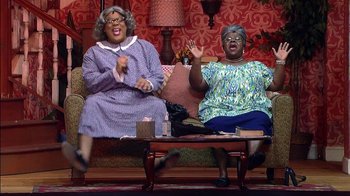Movie still from “Madea on the Run” (2017), directed by Derrick Doose – A couple of women sitting on top of a couch; Wide shot, Low angle