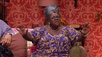 Movie still from “Madea on the Run” (2017), directed by Derrick Doose – An older woman wearing a wig and a blue and gold dress; Medium shot, High angle