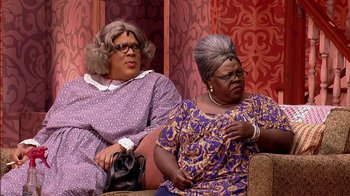 Movie still from “Madea on the Run” (2017), directed by Derrick Doose – A couple of women sitting next to each other on a couch; Medium shot, Over the shoulder angle