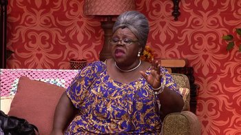 Movie still from “Madea on the Run” (2017), directed by Derrick Doose – An older woman sitting on top of a couch talking; Medium shot, High angle