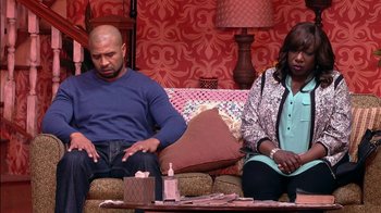 Movie still from “Madea on the Run” (2017), directed by Derrick Doose – A man and a woman sitting on a couch in a living room; Medium shot, Over the shoulder angle