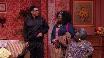 Movie still from “Madea on the Run” (2017), directed by Derrick Doose – A group of people standing next to each other in a room; Medium shot, Over the shoulder angle