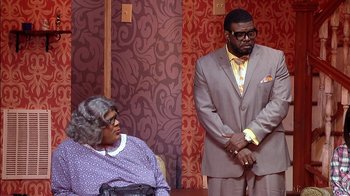 Movie still from “Madea on the Run” (2017), directed by Derrick Doose – A man and a woman standing next to each other; Wide shot, Over the shoulder angle