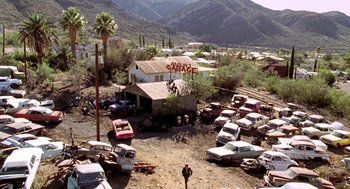 Movie still from “U Turn” (1997), directed by Oliver Stone – An aerial view of an abandoned car lot; Extreme Wide shot, High angle