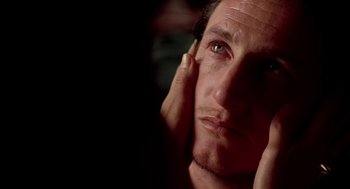 Movie still from “U Turn” (1997), directed by Oliver Stone – A person with his hand on his face; Extreme Close Up shot, Over the shoulder angle