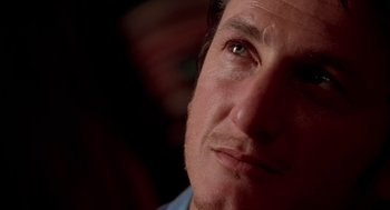Movie still from “U Turn” (1997), directed by Oliver Stone – A man's eyes and face; Close Up shot, Low angle