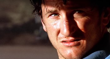Movie still from “U Turn” (1997), directed by Oliver Stone – A man's face as he stares into the distance; Close Up shot, Low angle
