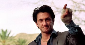 Movie still from “U Turn” (1997), directed by Oliver Stone – A person with a hand in the air; Close Up shot, Low angle