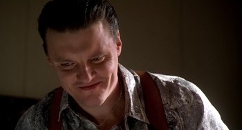 Movie still from “U Turn” (1997), directed by Oliver Stone – A person wearing a shirt and tie; Close Up shot, Low angle