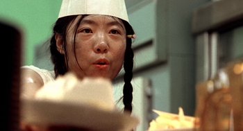 Movie still from “U Turn” (1997), directed by Oliver Stone – A young girl wearing a white paper hat; Close Up shot, Low angle