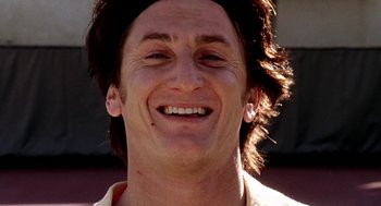 Movie still from “U Turn” (1997), directed by Oliver Stone – A person smiling with his head tilted back; Close Up shot, Low angle