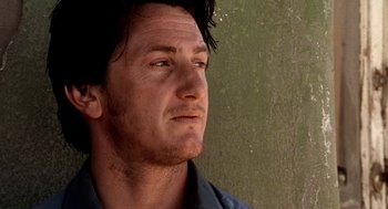 Movie still from “U Turn” (1997), directed by Oliver Stone – A person looking up at a wall; Close Up shot, Low angle